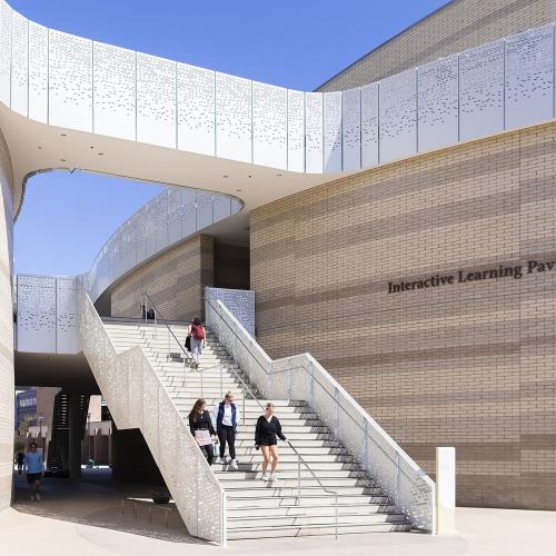 Student walking onstairs of front entrance of UCSB Interactive Learning Pavilion